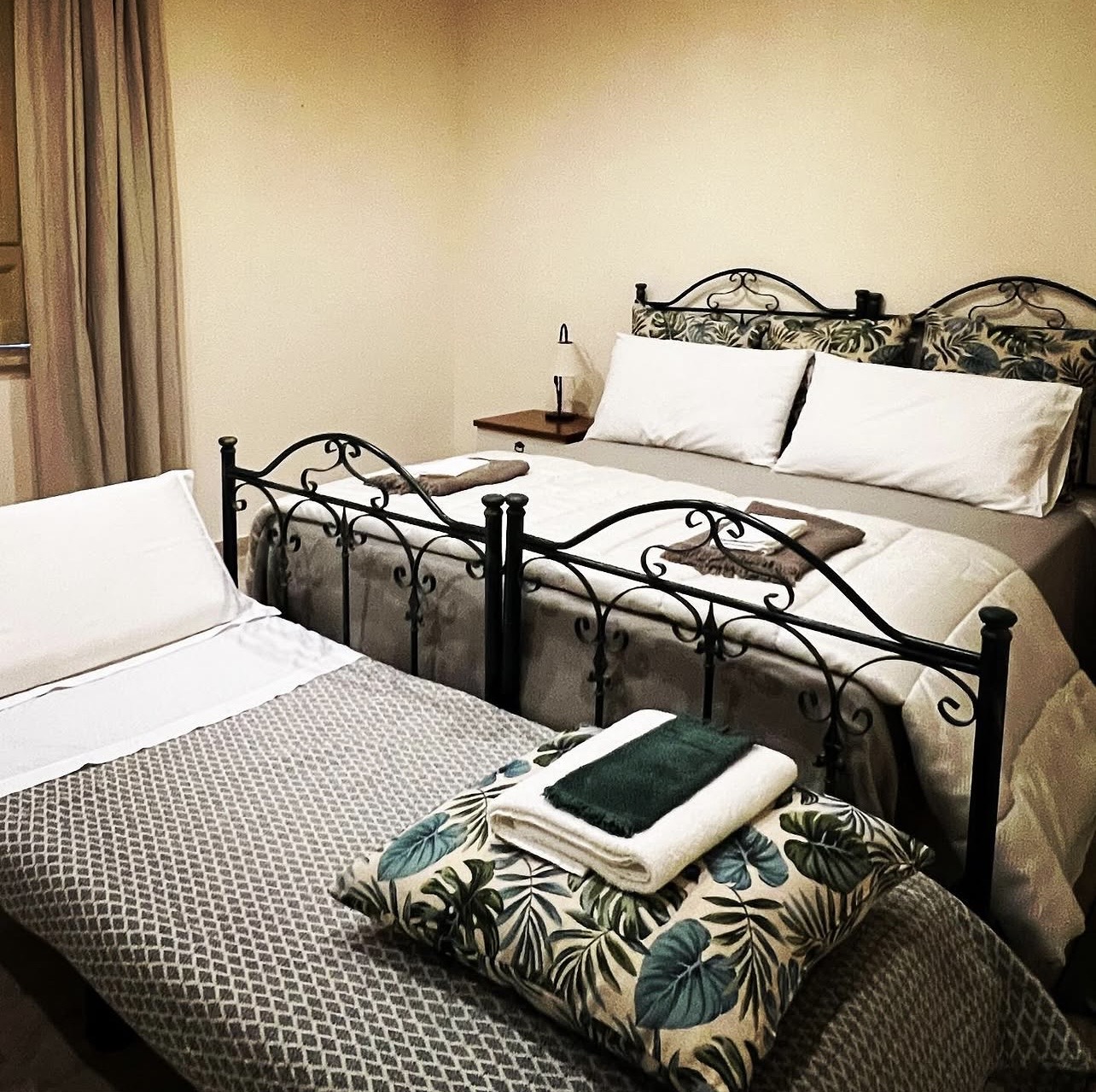 Twin and double beds with wrought iron frames