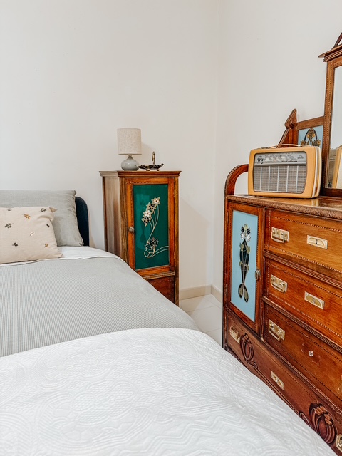 Bedroom with vintage wooden dresser and radio