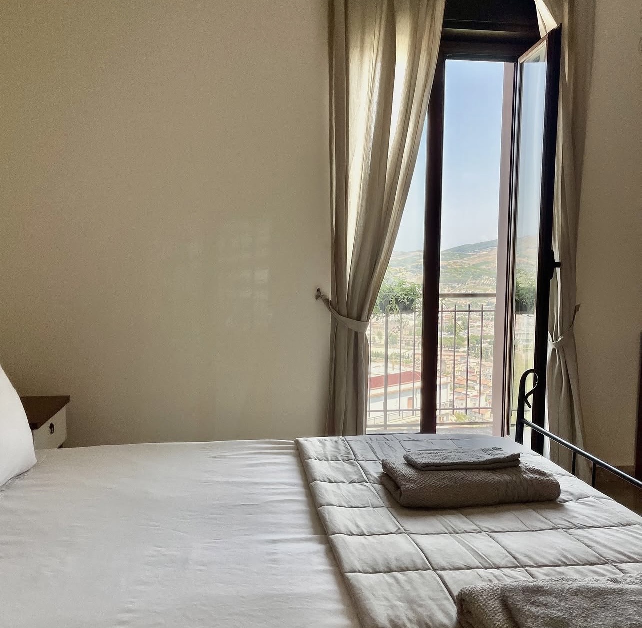 Bedroom with balcony doors open over Salemi