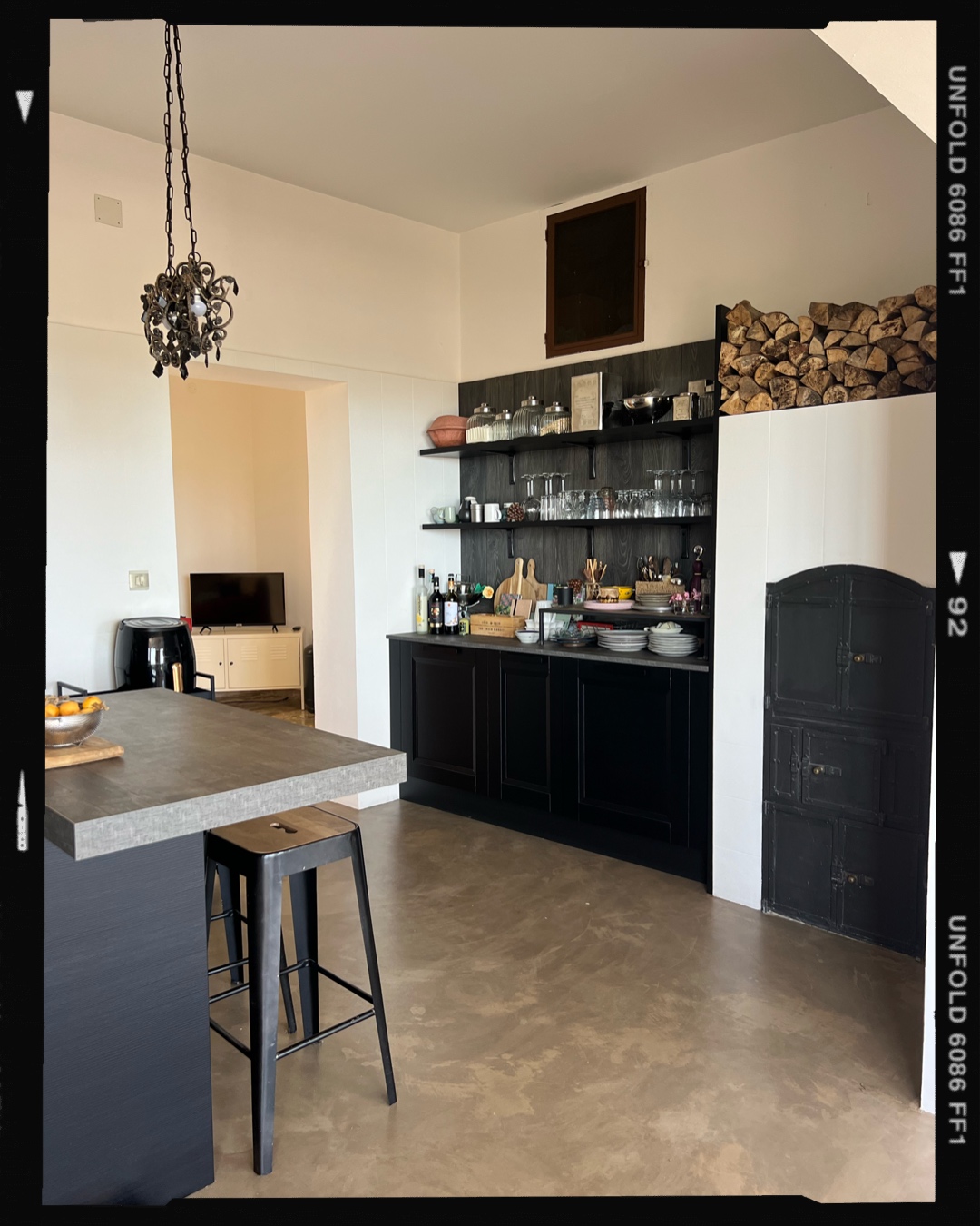 Black designer kitchen with island and open shelving