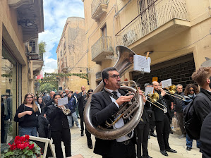 A brass band marching through the narrow streets of Salemi during a town procession